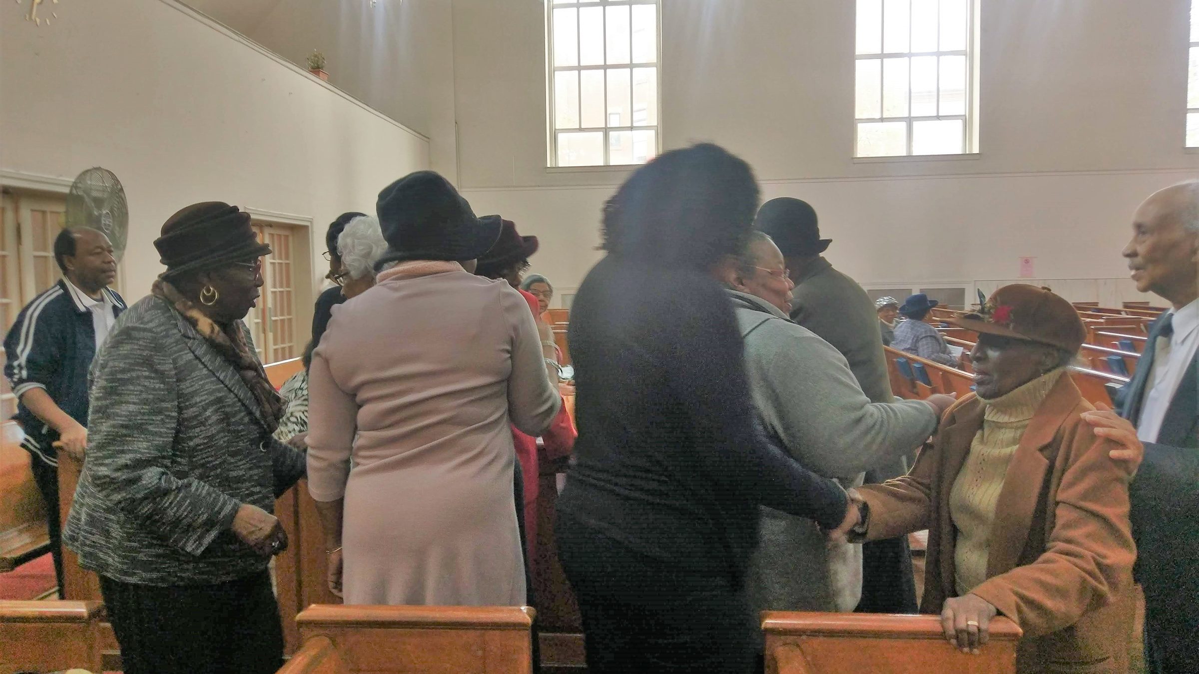 Members of Siloam Presbyterian Church greeting one another in the sanctuary